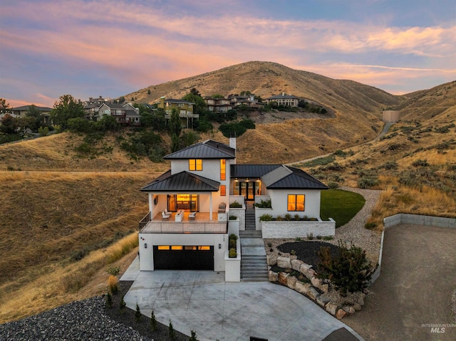 view of front of property featuring a garage and a mountain view