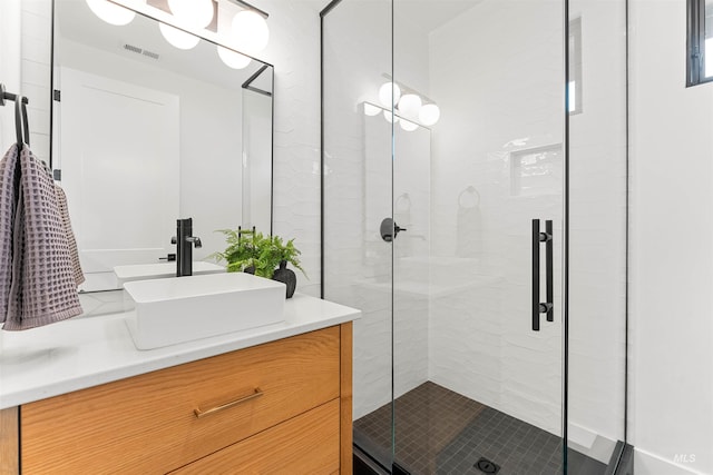 bathroom with walk in shower and vanity