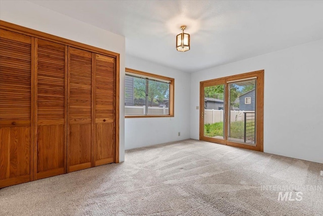 1915 N 23rd St, Boise, ID 83702 - unfurnished bedroom featuring carpet flooring, access to exterior, and a closet