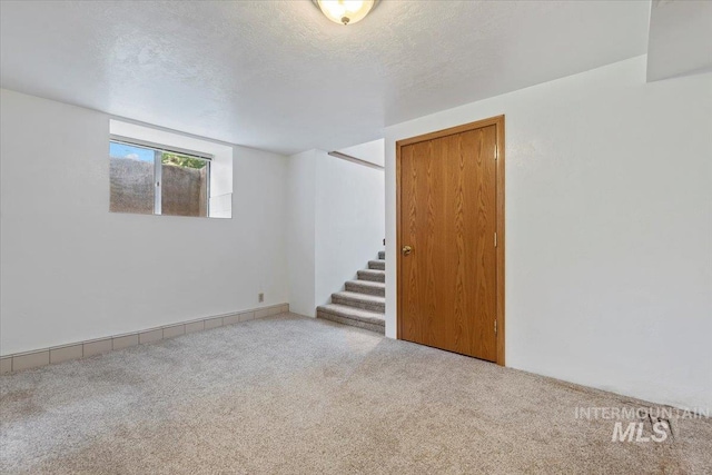 1915 N 23rd St, Boise, ID 83702 - carpeted spare room with stairway and a textured ceiling