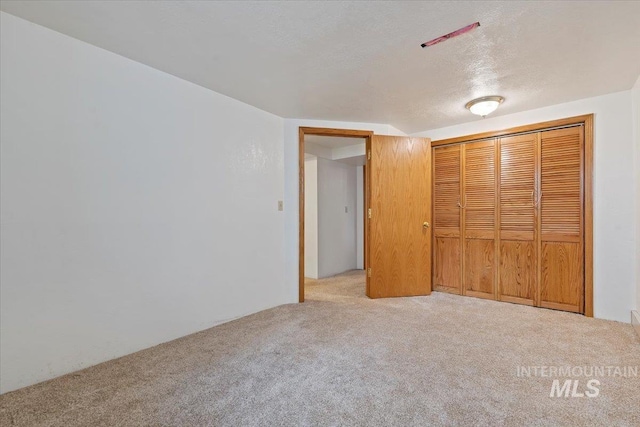 1915 N 23rd St, Boise, ID 83702 - unfurnished bedroom featuring carpet flooring, a textured ceiling, and a closet
