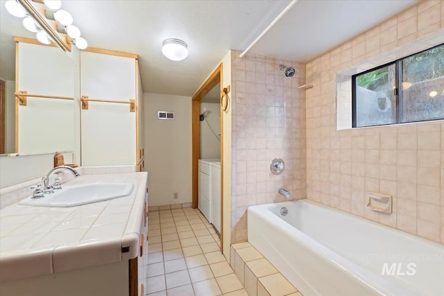 1915 N 23rd St, Boise, ID 83702 - bathroom featuring tile patterned floors, shower / bath combination, vanity, and washer / clothes dryer