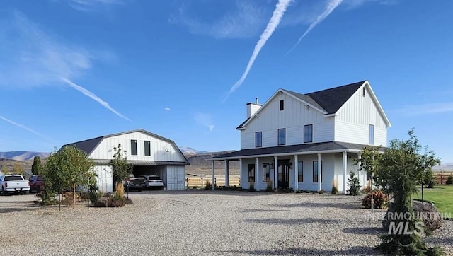 modern farmhouse with a mountain view and covered porch