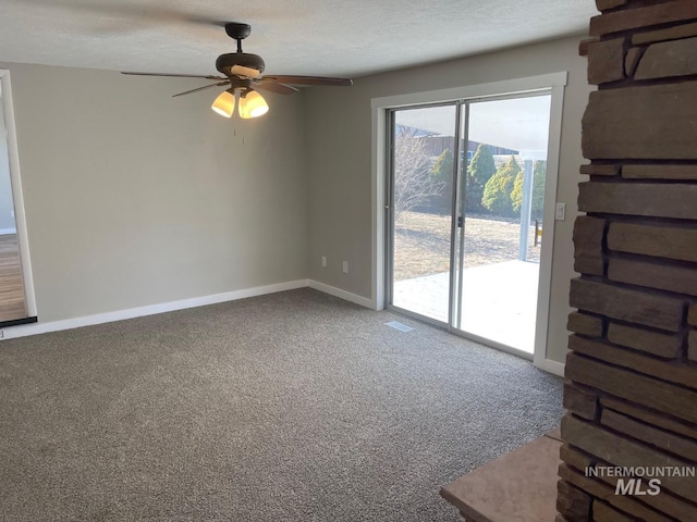 interior space featuring ceiling fan, a textured ceiling, and carpet