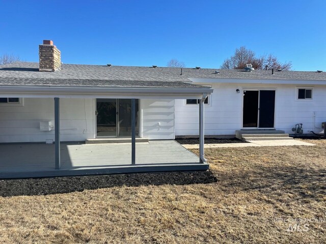 back of house with a wooden deck and a yard