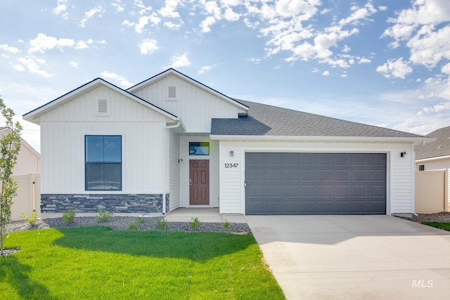 view of front of property with a garage and a front yard