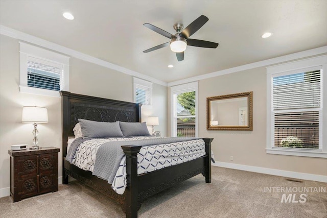 bedroom with ceiling fan, crown molding, and light carpet