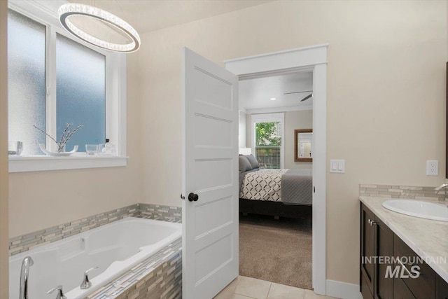 bathroom featuring tile patterned floors, ceiling fan, vanity, and a relaxing tiled tub