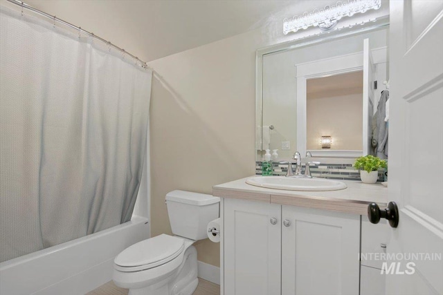 full bathroom with vanity, shower / bathtub combination with curtain, and toilet