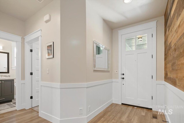 entryway with light hardwood / wood-style floors