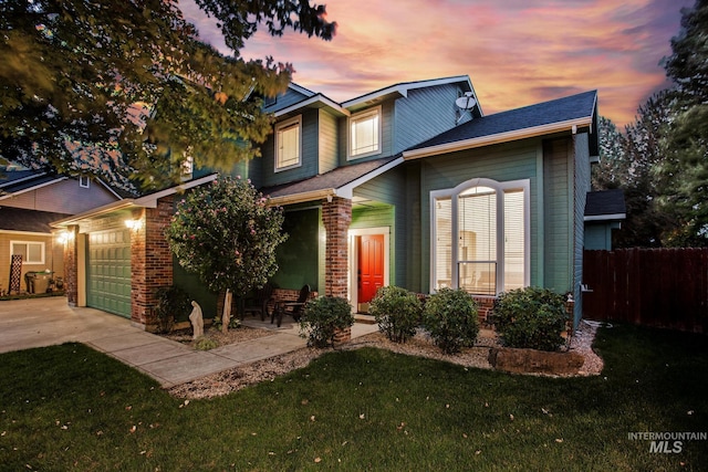 view of front of home with a yard and a garage