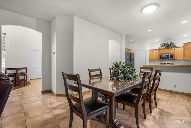 dining space featuring light tile patterned flooring