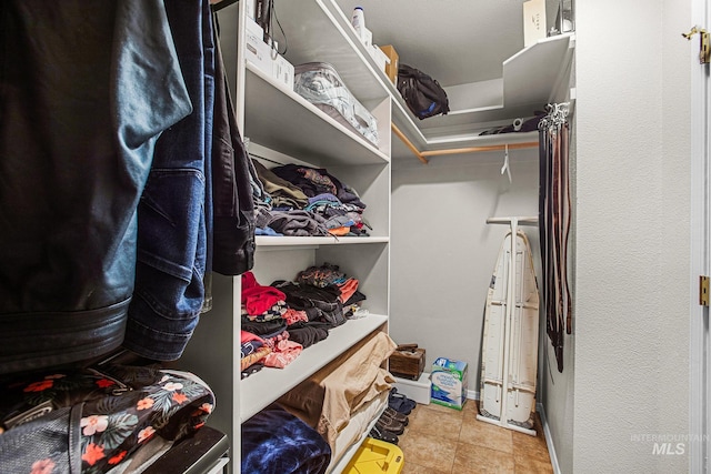 spacious closet featuring light tile patterned flooring