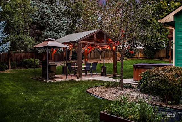 view of home's community with a gazebo, a lawn, and a hot tub