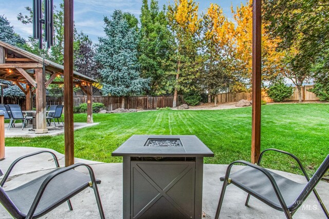 view of patio featuring a gazebo and an outdoor fire pit