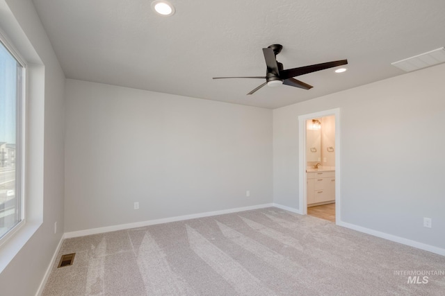 empty room featuring light colored carpet and ceiling fan