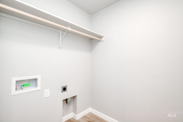 washroom featuring electric dryer hookup, washer hookup, and light hardwood / wood-style floors