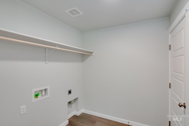 laundry room featuring washer hookup, hardwood / wood-style floors, and electric dryer hookup