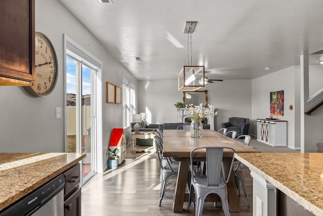 dining room featuring light wood finished floors and a ceiling fan