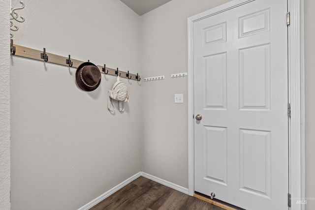 interior space featuring baseboards and dark wood-type flooring