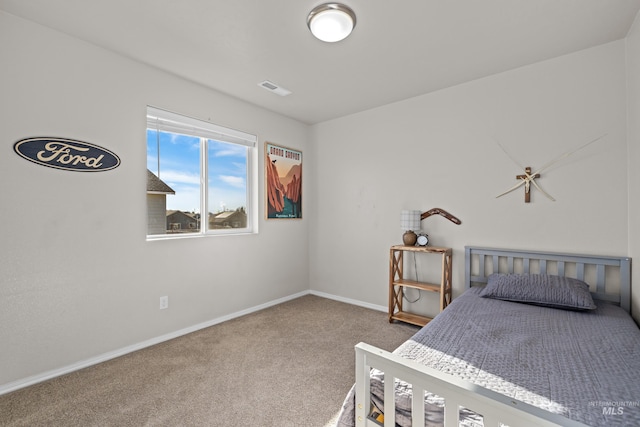 carpeted bedroom with visible vents and baseboards