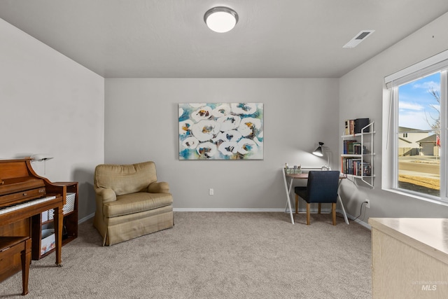 home office with baseboards, visible vents, and light colored carpet