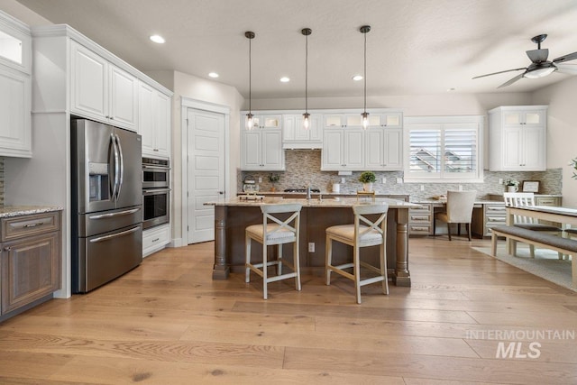 kitchen with white cabinets, recessed lighting, backsplash, and appliances with stainless steel finishes