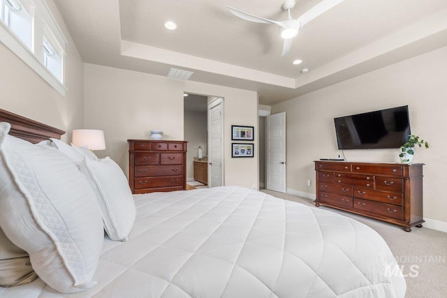 bedroom featuring recessed lighting, a raised ceiling, visible vents, and baseboards