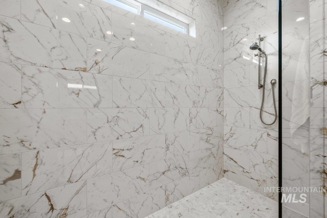 full bath featuring a marble finish shower