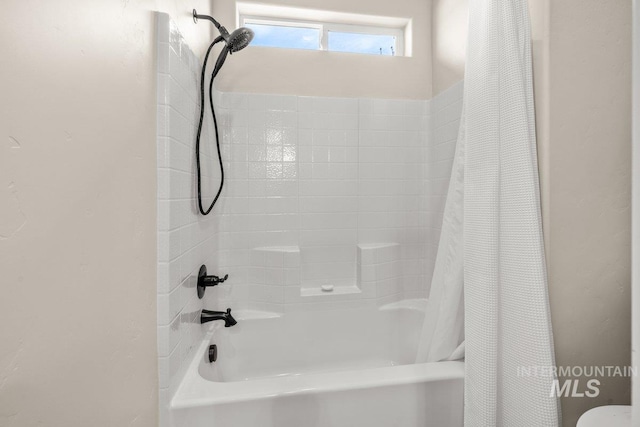 bathroom featuring shower / tub combo with curtain