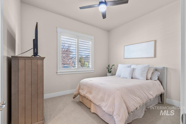 carpeted bedroom featuring a ceiling fan and baseboards