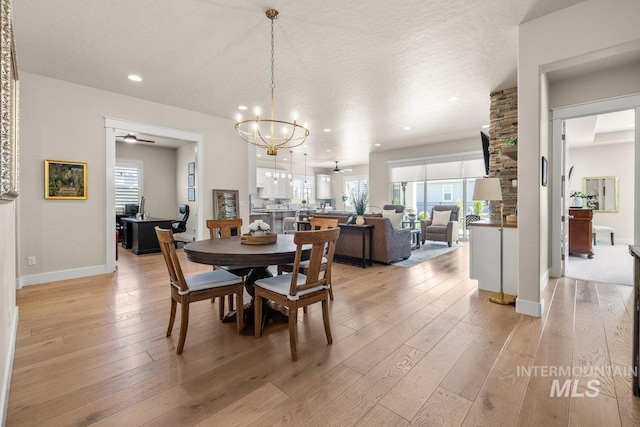 dining room featuring light wood finished floors, baseboards, a wealth of natural light, and recessed lighting