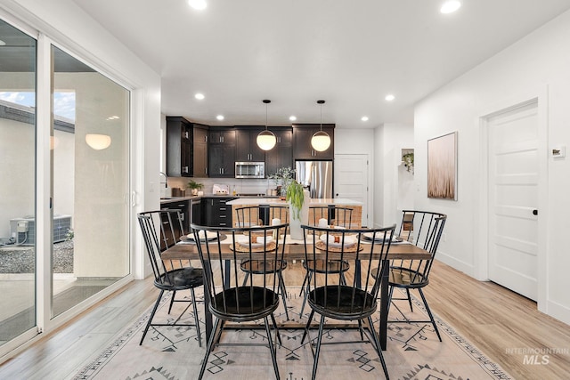 dining space featuring sink and light hardwood / wood-style floors