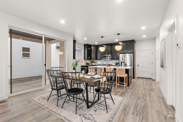 dining space with light wood-type flooring