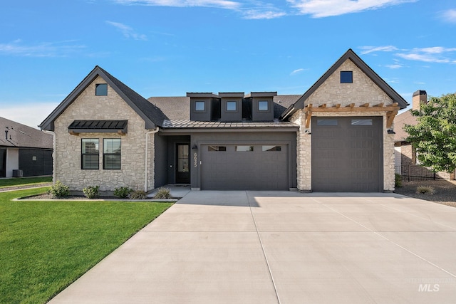 6635 Big Wood Way, Star, ID 83669 - french country inspired facade with stone siding, driveway, a standing seam roof, an attached garage, and a front lawn