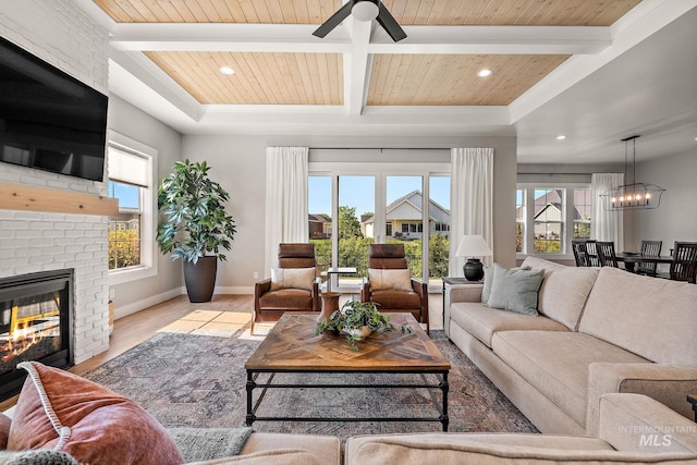 6635 Big Wood Way, Star, ID 83669 - living area featuring wood finished floors, a fireplace, a ceiling fan, a chandelier, and baseboards