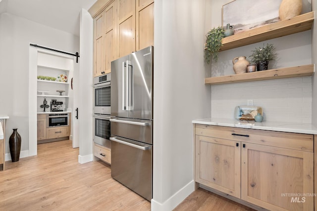 6635 Big Wood Way, Star, ID 83669 - kitchen featuring appliances with stainless steel finishes, open shelves, light wood-style flooring, and tasteful backsplash