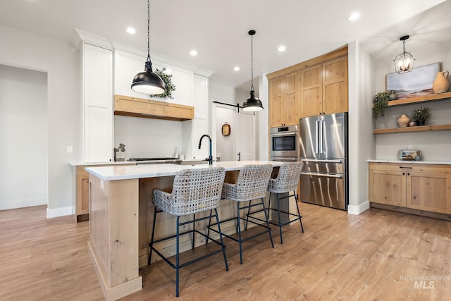 6635 Big Wood Way, Star, ID 83669 - kitchen with high quality fridge, light countertops, baseboards, recessed lighting, and light wood-style flooring