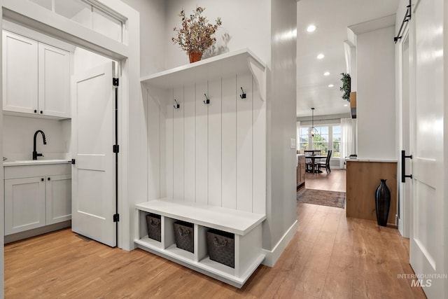 6635 Big Wood Way, Star, ID 83669 - mudroom with a sink, light wood-style floors, recessed lighting, and baseboards