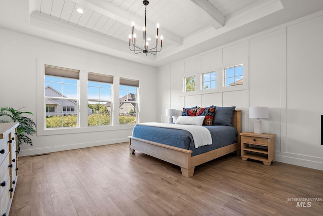 6635 Big Wood Way, Star, ID 83669 - bedroom featuring a chandelier, wood finished floors, baseboards, and wooden ceiling with exposed beams