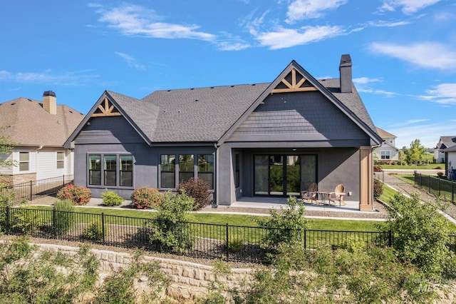 6635 Big Wood Way, Star, ID 83669 - rear view of house featuring a chimney, stucco siding, a patio area, a fenced backyard, and a shingled roof