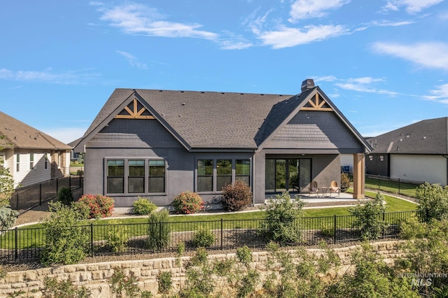 6635 Big Wood Way, Star, ID 83669 - rear view of house with a patio, roof with shingles, stucco siding, and a chimney