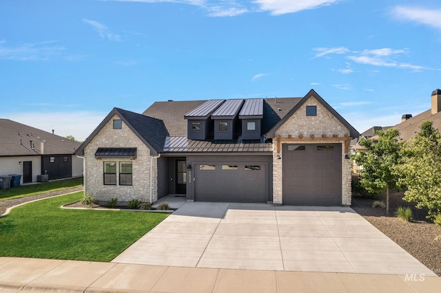 6635 Big Wood Way, Star, ID 83669 - view of front of home featuring stone siding, a standing seam roof, a front yard, a garage, and concrete driveway