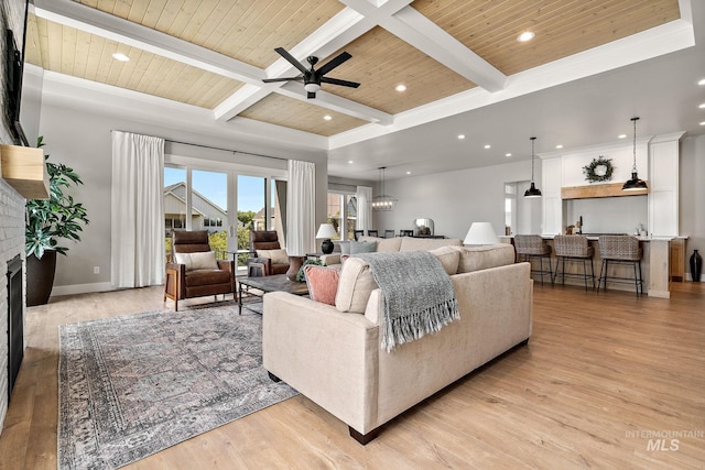 6635 Big Wood Way, Star, ID 83669 - living room featuring a ceiling fan, light wood finished floors, a brick fireplace, wooden ceiling with exposed beams, and baseboards
