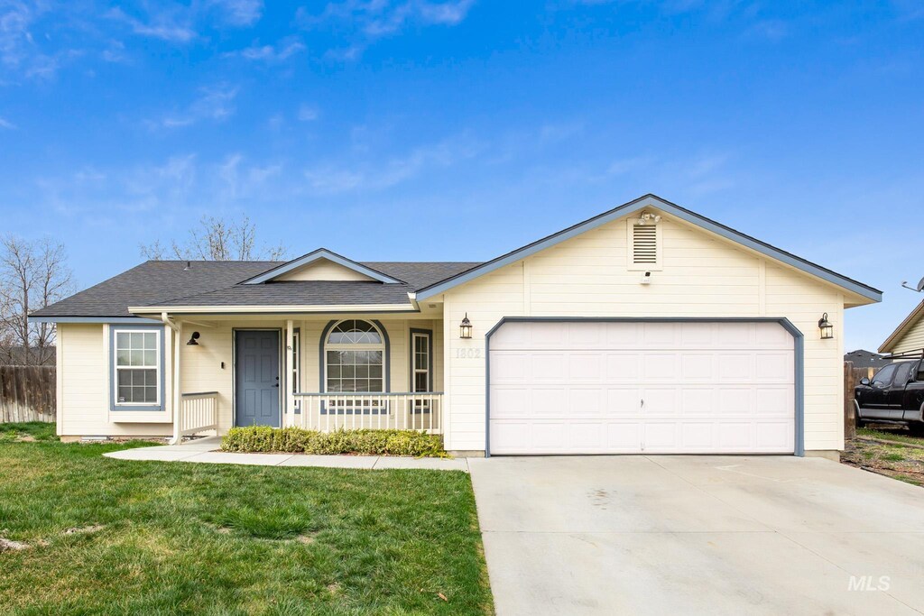1802 Silver Loop, Nampa, ID 83686 - single story home featuring an attached garage, concrete driveway, a front yard, a shingled roof, and a porch