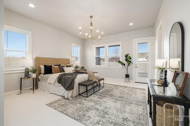 bedroom featuring multiple windows, carpet flooring, baseboards, and a chandelier