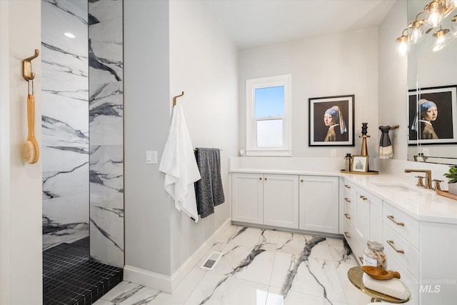 full bath with visible vents, a marble finish shower, double vanity, a sink, and marble finish floor