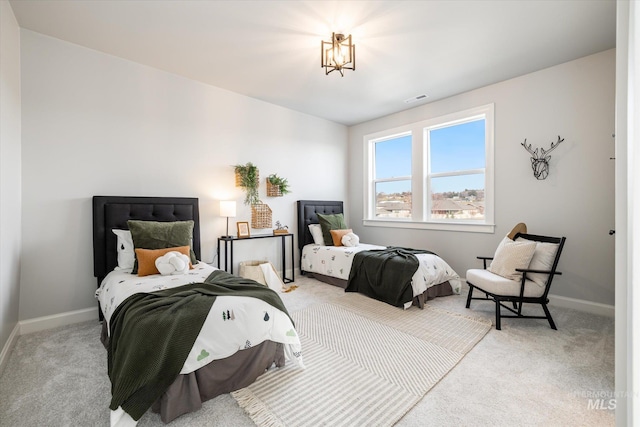 carpeted bedroom with visible vents and baseboards