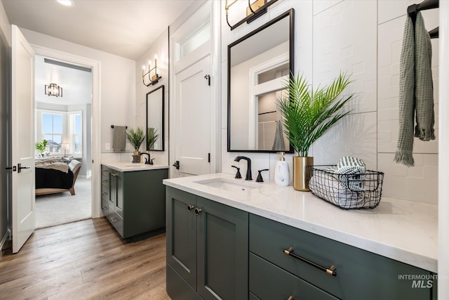 full bathroom featuring recessed lighting, vanity, ensuite bathroom, and wood finished floors