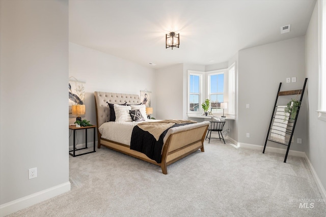 carpeted bedroom with visible vents and baseboards